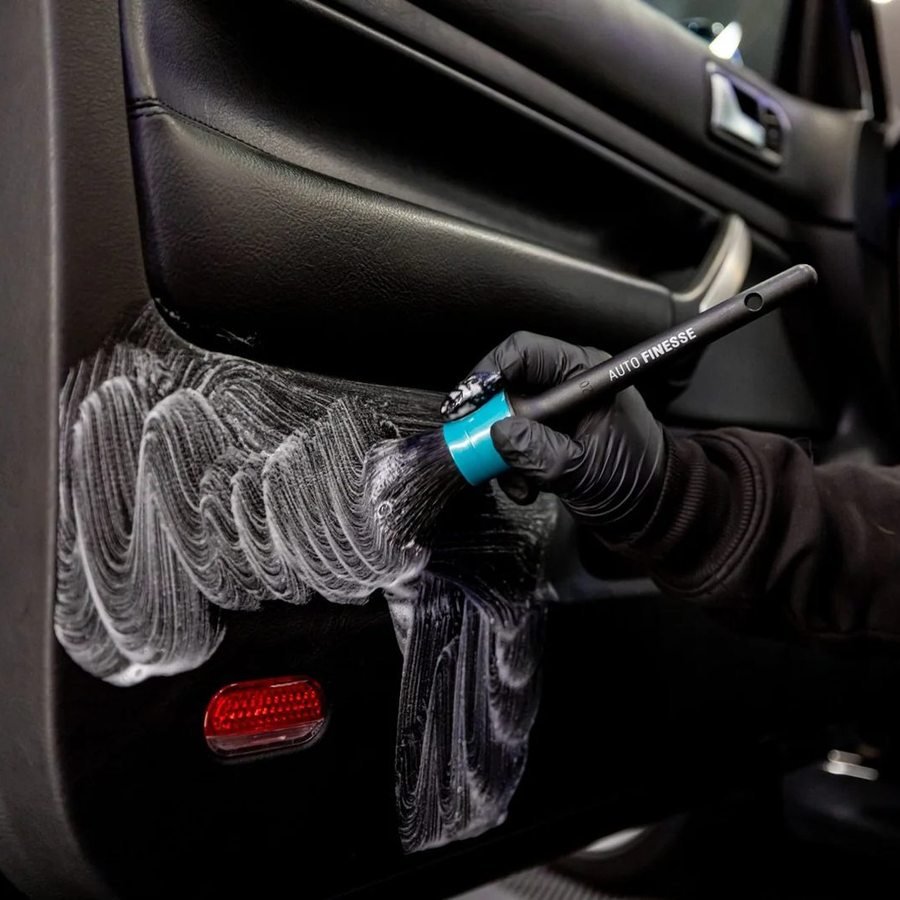 Leather door card cleaned with a soft detailing brush