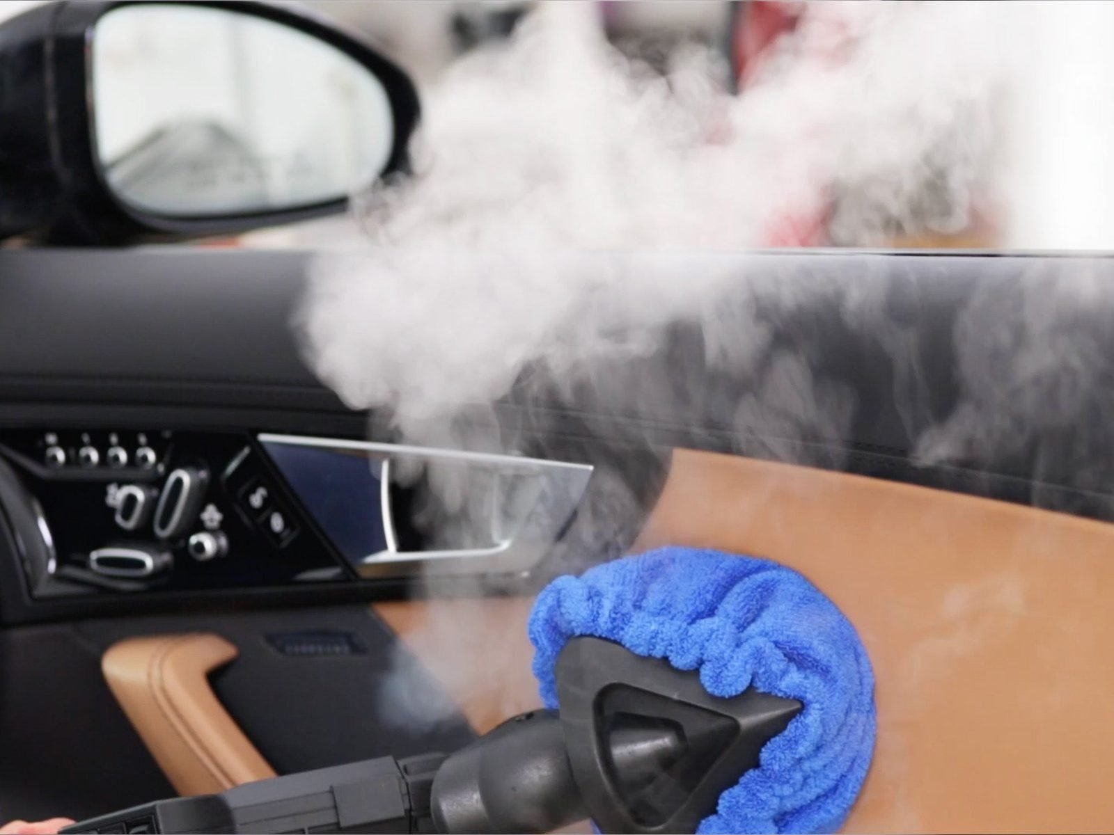 Steam cleaning a door panel and jamb