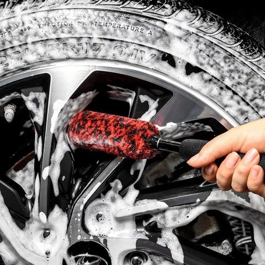 Wheel brush cleaning a foam covered alloy wheel