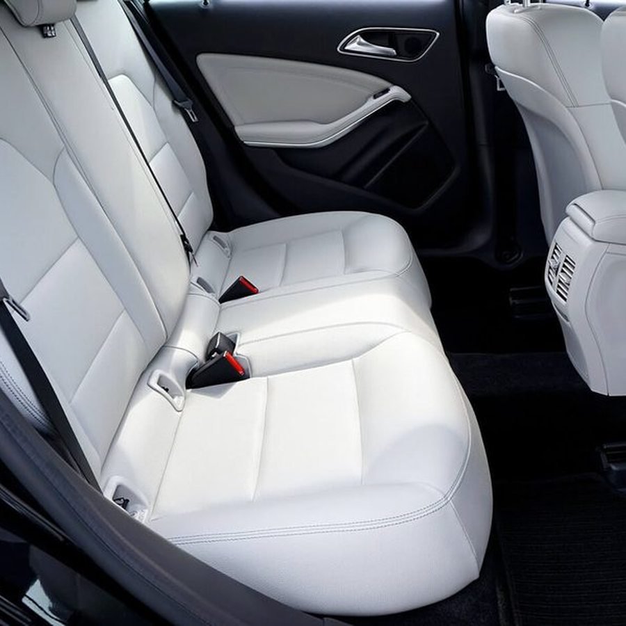 White leather interior cleaned and conditioned during an interior detail